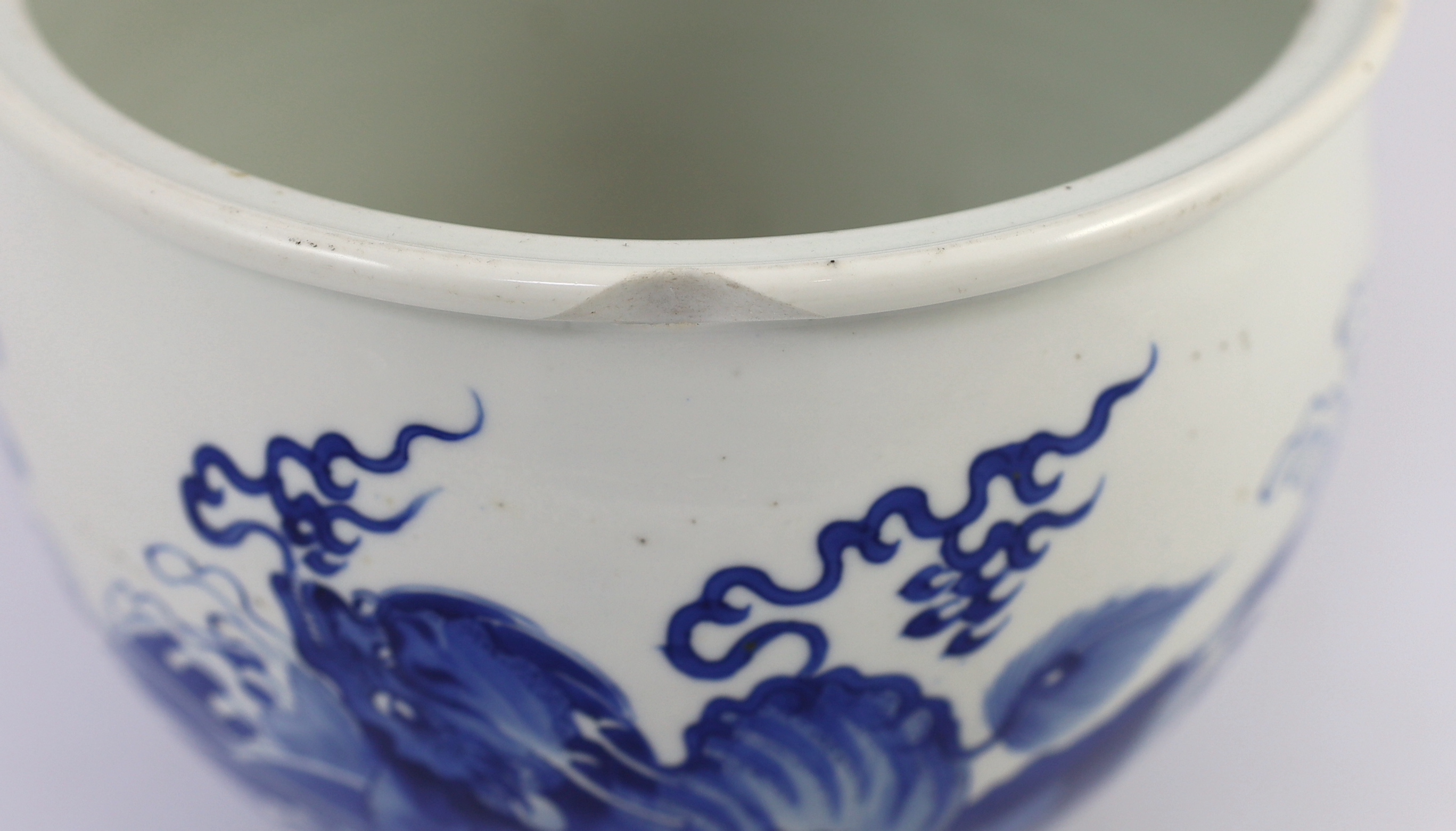 A Chinese blue and white ‘mythical beasts’ jardiniere, Kangxi period, chip and glaze losses to rim